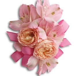 Pink and peach floral corsage with ribbon accents