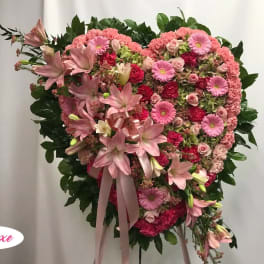 Heart-shaped pink floral standing spray with lilies and roses