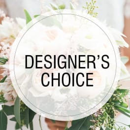 White floral bouquet with greenery and a "Designer’s Choice" label