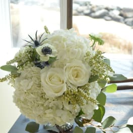 White rose and hydrangea bouquet with green foliage