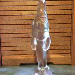Frosted glass figurine of a robed woman standing on a round base