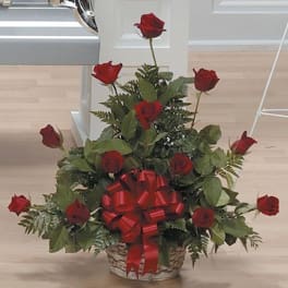 Basket arrangement of red roses with a large red bow