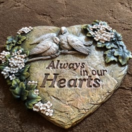 Heart-shaped decorative plaque with two birds and flowers, reading "Always in our Hearts"