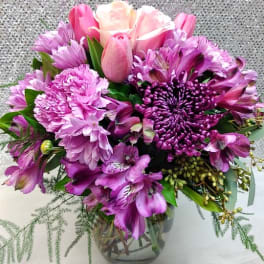 Pink and purple bouquet in a clear glass vase