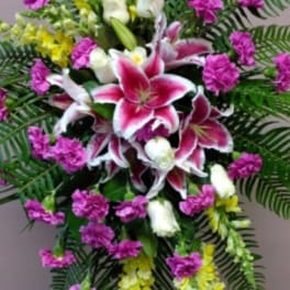 Standing floral spray with pink lilies and purple carnations
