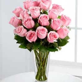 Pink roses arranged in a clear glass vase