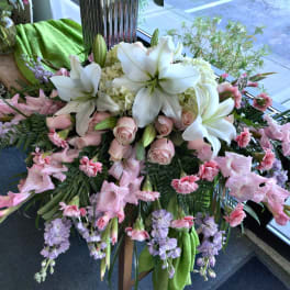 Large pink and white floral arrangement with lilies and roses