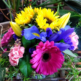 Bright mixed bouquet with sunflowers, gerbera daisies, irises, and carnations