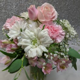 Pink and white bouquet in a clear glass vase