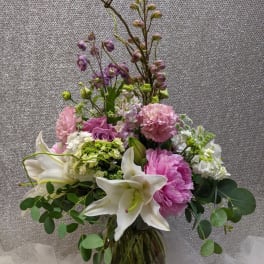 Pink and white floral arrangement in a glass vase