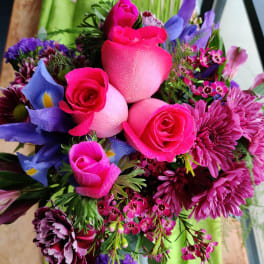 Bouquet of pink roses, purple blooms, and mixed flowers