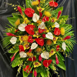 Large tropical floral spray with red and white anthuriums and yellow orchids