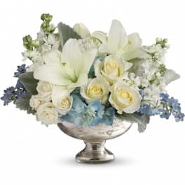 White lilies and roses in a silver pedestal vase