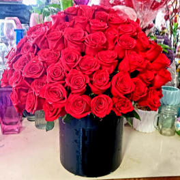 Large bouquet of red roses in a black vase