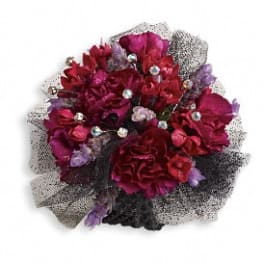Bouquet of deep red and purple flowers with black mesh wrapping