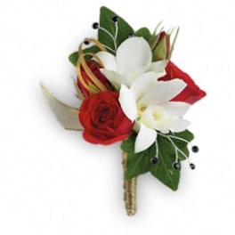 Red and white floral boutonniere with green leaves and gold accents