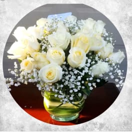 White roses and baby's breath in a glass vase