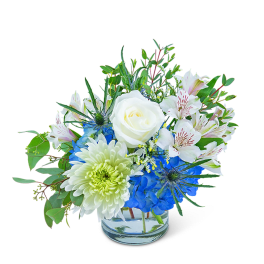 Blue and white mixed bouquet in a clear glass vase