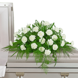 White carnation casket spray with green foliage