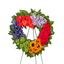 Colorful floral wreath on a stand with roses, hydrangea, and sunflowers