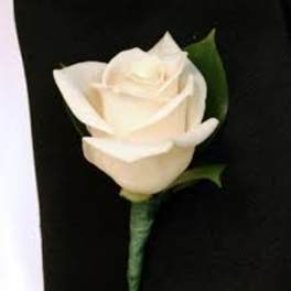 White rose boutonniere on a black suit jacket