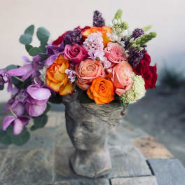 Colorful rose bouquet in a sculpted gray vase