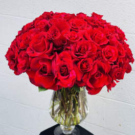 Large bouquet of red roses in a clear glass vase