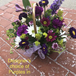 Purple and white mixed flower basket with a ribbon handle