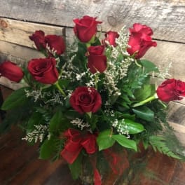 Bouquet of red roses with white filler in a glass vase
