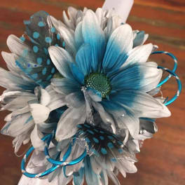 Blue and white daisy bouquet with decorative feathers and ribbon
