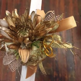 Gold-toned floral corsage with ribbon and mesh accents