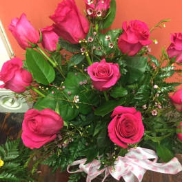 Bouquet of hot pink roses with greenery and a pink polka-dot ribbon