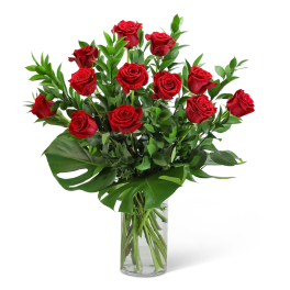 Red roses arranged in a clear glass vase