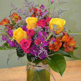 Colorful bouquet of roses and alstroemeria in a glass vase