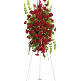 Tall red floral standing spray on a white easel