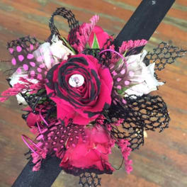 Pink and black rose boutonniere with lace accents