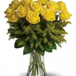 Yellow roses arranged in a clear glass vase