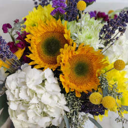Bouquet of sunflowers, white hydrangea, and purple filler flowers