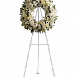 White floral funeral wreath on a standing easel