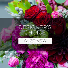 Mixed bouquet of red and pink flowers with green foliage