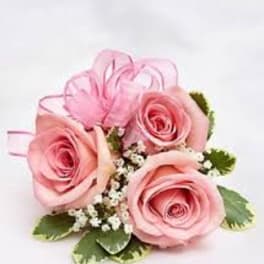 Pink rose corsage with baby's breath and ribbon