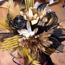 Black, gold, and white floral hair accessory with feathers
