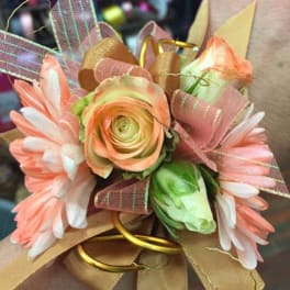 Corsage with peach and white flowers and pink ribbon