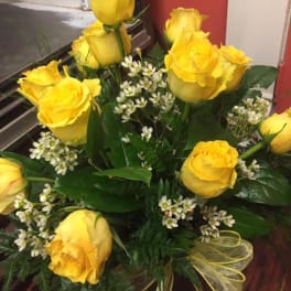 Bouquet of yellow roses with small white filler flowers