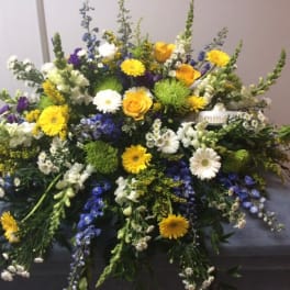 Large mixed floral spray with yellow, white, purple, and blue blooms