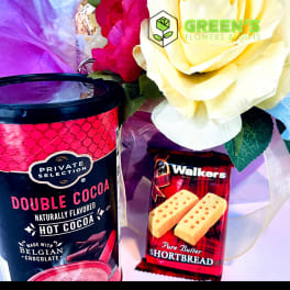 Gift set with a rose bouquet, hot cocoa, and shortbread cookies
