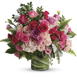Pink and purple rose bouquet in a glass vase