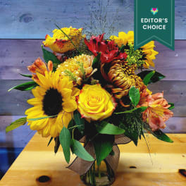 Bouquet of yellow and red flowers in a glass vase