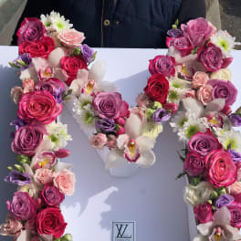 Floral letter arrangement with pink and white roses and orchids