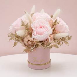 Pink rose arrangement in a round box with gold accents